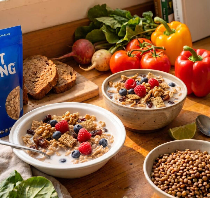 Bowls of oats topped with berries beside fresh vegetables